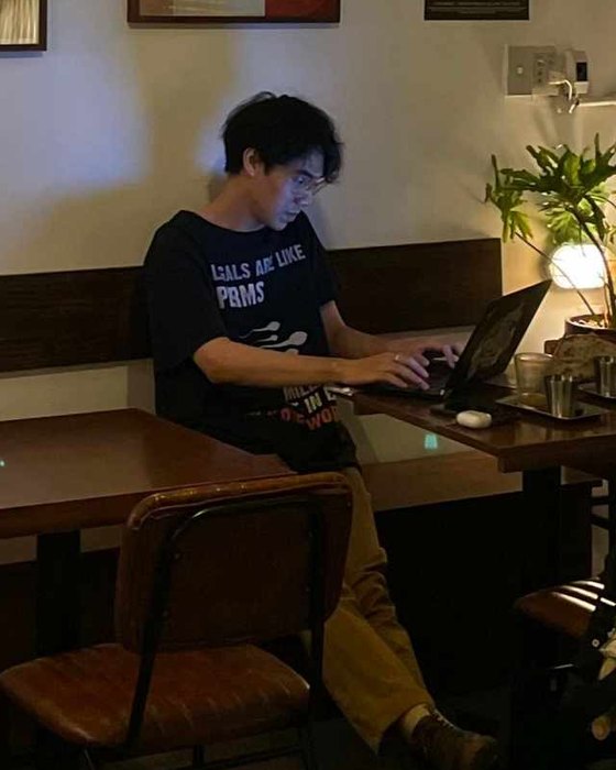 Binh Ho working on a laptop in a café